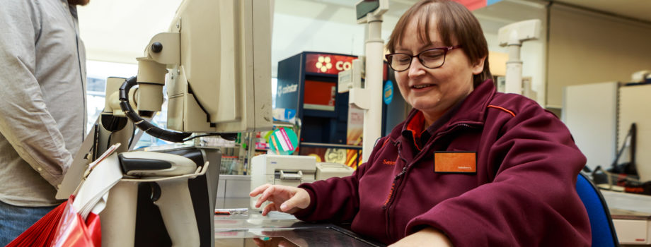 Image of a Sainsbury's cashier serving a customer
