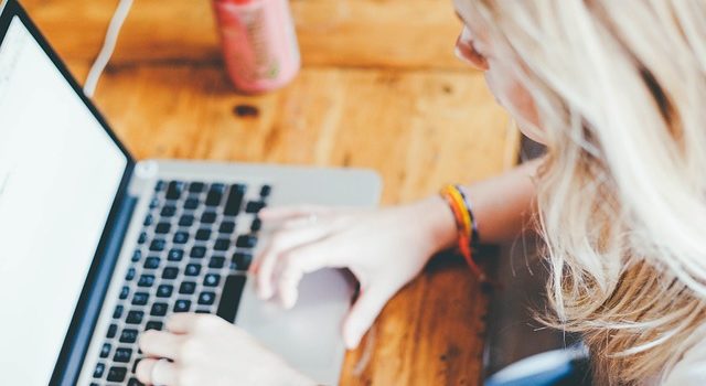 Woman typing on her laptop