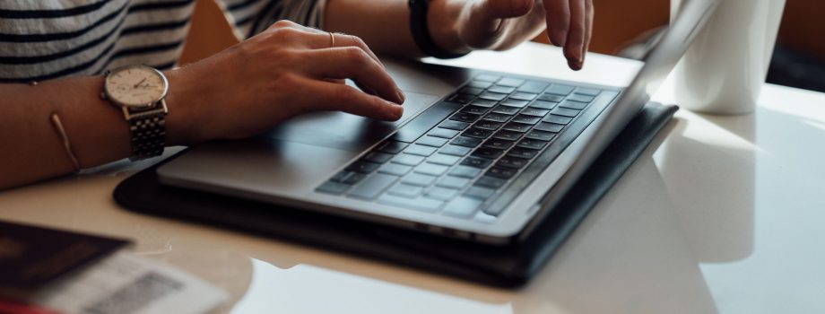 person seated at the table using laptop