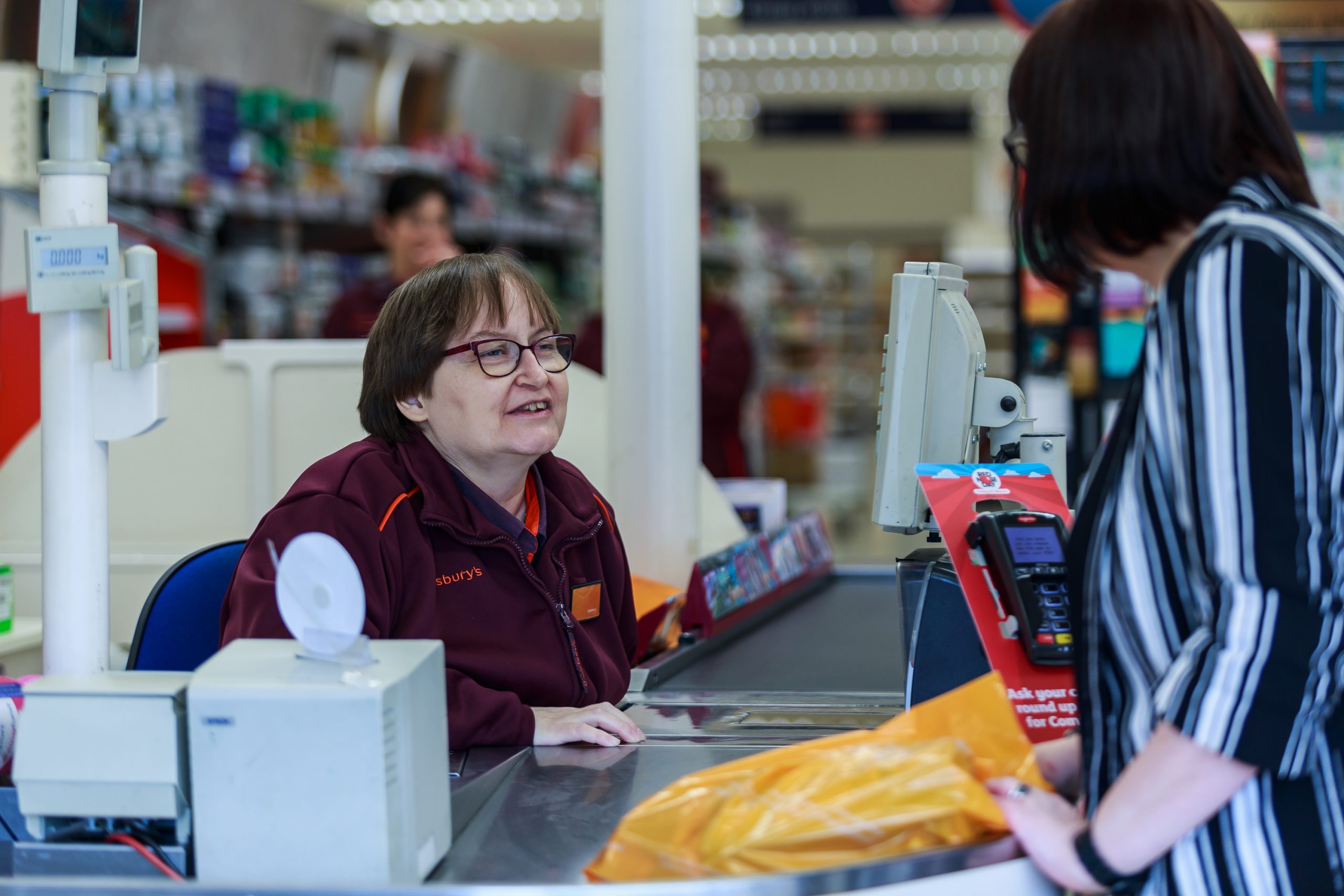 Cashier and female customer in conversation