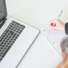woman writing on notebook