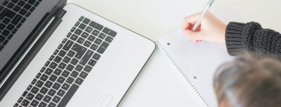 woman writing on notebook