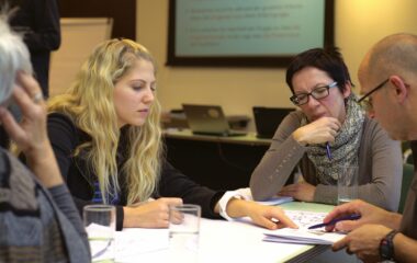 Four people in a meeting exchanging ideas